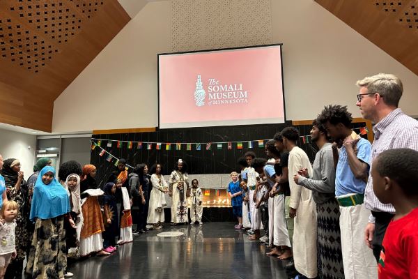 Group standing in opposite lines learning a Somali dance